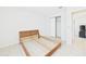 Empty bedroom featuring tile floors, bare wood frame, and closet at 31 Wagon Cir, Kissimmee, FL 34743