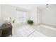Light-filled entryway with neutral tile flooring, a window, and view of the front door at 31 Wagon Cir, Kissimmee, FL 34743