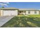 Charming single-story home with a well-manicured lawn and a two-car garage at 31 Wagon Cir, Kissimmee, FL 34743