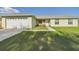 Charming single-story home with well-manicured lawn, white shutters, and two car garage at 31 Wagon Cir, Kissimmee, FL 34743
