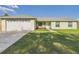 Charming single-story home with a well-manicured lawn and a two-car garage at 31 Wagon Cir, Kissimmee, FL 34743