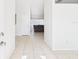 Bright foyer with neutral tile flooring leading into the main living space at 31 Wagon Cir, Kissimmee, FL 34743