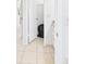 Bright hallway featuring tiled floors and a view into a closet, showcasing clean and simple design at 31 Wagon Cir, Kissimmee, FL 34743
