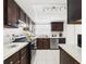 Well-maintained kitchen with wooden cabinets, stainless steel appliances, and ample counter space at 31 Wagon Cir, Kissimmee, FL 34743