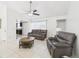 Relaxing living room featuring neutral walls, tile floors, ceiling fan and modern furnishings at 31 Wagon Cir, Kissimmee, FL 34743