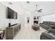 Comfortable living room featuring neutral walls, tile floors, modern furnishings, and a ceiling fan at 31 Wagon Cir, Kissimmee, FL 34743