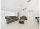 Cozy living room with tile floors, ceiling fan, and comfortable seating arrangement at 31 Wagon Cir, Kissimmee, FL 34743