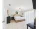 Spacious bedroom featuring a woven bed frame, tile flooring, and sliding glass doors at 31 Wagon Cir, Kissimmee, FL 34743
