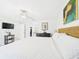 Bright bedroom boasts a woven bed, tile floors, and an ensuite bathroom at 31 Wagon Cir, Kissimmee, FL 34743