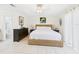 Bright bedroom with a woven bed, neutral bedding, and ensuite bath access at 31 Wagon Cir, Kissimmee, FL 34743