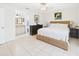 Bright bedroom featuring a woven bed, neutral bedding, and ensuite bath at 31 Wagon Cir, Kissimmee, FL 34743