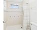 Tiled shower with a window and a decorative shower curtain at 31 Wagon Cir, Kissimmee, FL 34743