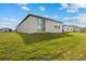 Well-maintained backyard with lush green grass and a sliding glass door that provides access to the home at 3821 Giorgio Dr, Winter Haven, FL 33884