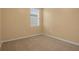 Bright bedroom featuring neutral walls, carpeted flooring, and a window with blinds at 3821 Giorgio Dr, Winter Haven, FL 33884