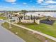 Inviting Villa Mar community entrance with lush landscaping, a playground, and a serene lake in the background at 3821 Giorgio Dr, Winter Haven, FL 33884