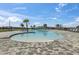 Inviting community pool with a shallow entry, palm trees, and a view of the surrounding neighborhood at 3821 Giorgio Dr, Winter Haven, FL 33884