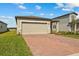 Charming single-story home featuring a brick driveway and attached two-car garage at 3821 Giorgio Dr, Winter Haven, FL 33884