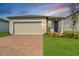 Charming single-story home with brick driveway, two-car garage, manicured lawn and well-maintained landscaping at 3821 Giorgio Dr, Winter Haven, FL 33884