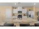 Modern kitchen featuring white cabinets, stainless steel appliances, a granite countertop island, and bar seating at 3821 Giorgio Dr, Winter Haven, FL 33884