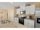 Contemporary kitchen with white cabinets, stainless steel appliances, and a granite countertop island sink at 3821 Giorgio Dr, Winter Haven, FL 33884