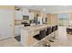 Bright, open kitchen with a long island, breakfast bar seating, stainless steel appliances, and white cabinetry at 3821 Giorgio Dr, Winter Haven, FL 33884