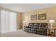 Comfortable living room featuring a leather sofa, neutral walls, window with blinds and tiled flooring at 3821 Giorgio Dr, Winter Haven, FL 33884