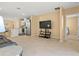 Open living area features a large TV, tile floors and flows into the kitchen at 3821 Giorgio Dr, Winter Haven, FL 33884