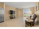 Living room with tile floors, entertainment center, view to outside and easy access to kitchen at 3821 Giorgio Dr, Winter Haven, FL 33884