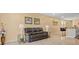 Inviting living room with a leather sofa, side tables, and artwork, next to the kitchen island at 3821 Giorgio Dr, Winter Haven, FL 33884