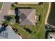Aerial view of a landscaped home with a neatly maintained lawn and brick driveway at 3834 Bedford Ave, Winter Haven, FL 33884