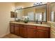 Bathroom features a double vanity with granite countertops and decorative mirrors at 3834 Bedford Ave, Winter Haven, FL 33884