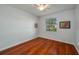 Bedroom with light-colored walls, wood floors and a large window overlooking greenery at 3834 Bedford Ave, Winter Haven, FL 33884