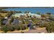 Aerial shot of the Traditions clubhouse with ample parking, landscaping, and lake views at 3834 Bedford Ave, Winter Haven, FL 33884