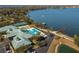 Traditions community pool, clubhouse, tennis courts, and lake access from an aerial perspective at 3834 Bedford Ave, Winter Haven, FL 33884