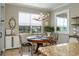 Cozy dining room with a round wood table, ornate chairs, a modern chandelier, and a view of the outdoors at 3834 Bedford Ave, Winter Haven, FL 33884