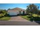 Charming single-story home with a manicured lawn and brick-paved driveway leading to a two-car garage at 3834 Bedford Ave, Winter Haven, FL 33884