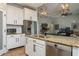 Open kitchen with granite countertops, stainless steel appliances, white cabinetry, and a view into the living area at 3834 Bedford Ave, Winter Haven, FL 33884