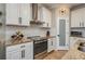 Well-lit kitchen features white cabinetry, granite countertops, stainless steel appliances, and a tile backsplash at 3834 Bedford Ave, Winter Haven, FL 33884