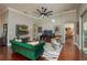 Elegant living room featuring a plush green sofa, hardwood floors, and stylish decor at 3834 Bedford Ave, Winter Haven, FL 33884