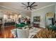 Open-concept living room with hardwood floors, plush seating, and an open view to the kitchen at 3834 Bedford Ave, Winter Haven, FL 33884