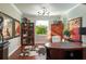 Home office with hardwood floors, an area rug, eclectic art and a view to the outside at 3834 Bedford Ave, Winter Haven, FL 33884