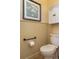 Half bathroom/powder room features a toilet with accessibility bars and an artistic print above the commode at 3834 Bedford Ave, Winter Haven, FL 33884