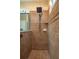 Tiled walk-in shower with a rain shower head, handheld sprayer, and mosaic tile accents, offering a spa-like experience at 3834 Bedford Ave, Winter Haven, FL 33884