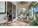Bright sunroom with comfortable seating, tile flooring, sliding glass doors, and views of the outdoor space at 3834 Bedford Ave, Winter Haven, FL 33884