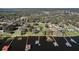 Aerial view of waterfront homes and docks on a tranquil lake surrounded by lush greenery at 3943 Chambers St, Lake Wales, FL 33898