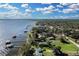 Picturesque aerial view of homes lining the waterfront with private docks, lake and lush greenery at 3943 Chambers St, Lake Wales, FL 33898