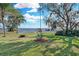 Picturesque backyard featuring a sprawling green lawn that slopes gently to the tranquil waters of the lake at 3943 Chambers St, Lake Wales, FL 33898