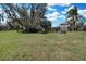 Expansive backyard leads to a lake, enhancing this homes charm with outdoor appeal, perfect for recreation and relaxation at 3943 Chambers St, Lake Wales, FL 33898