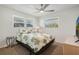Cozy bedroom with a bed, patterned bedding, and natural light streaming through the windows at 3943 Chambers St, Lake Wales, FL 33898