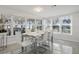 Bright dining room with modern tile floors and white table set with six chairs near sunny windows at 3943 Chambers St, Lake Wales, FL 33898